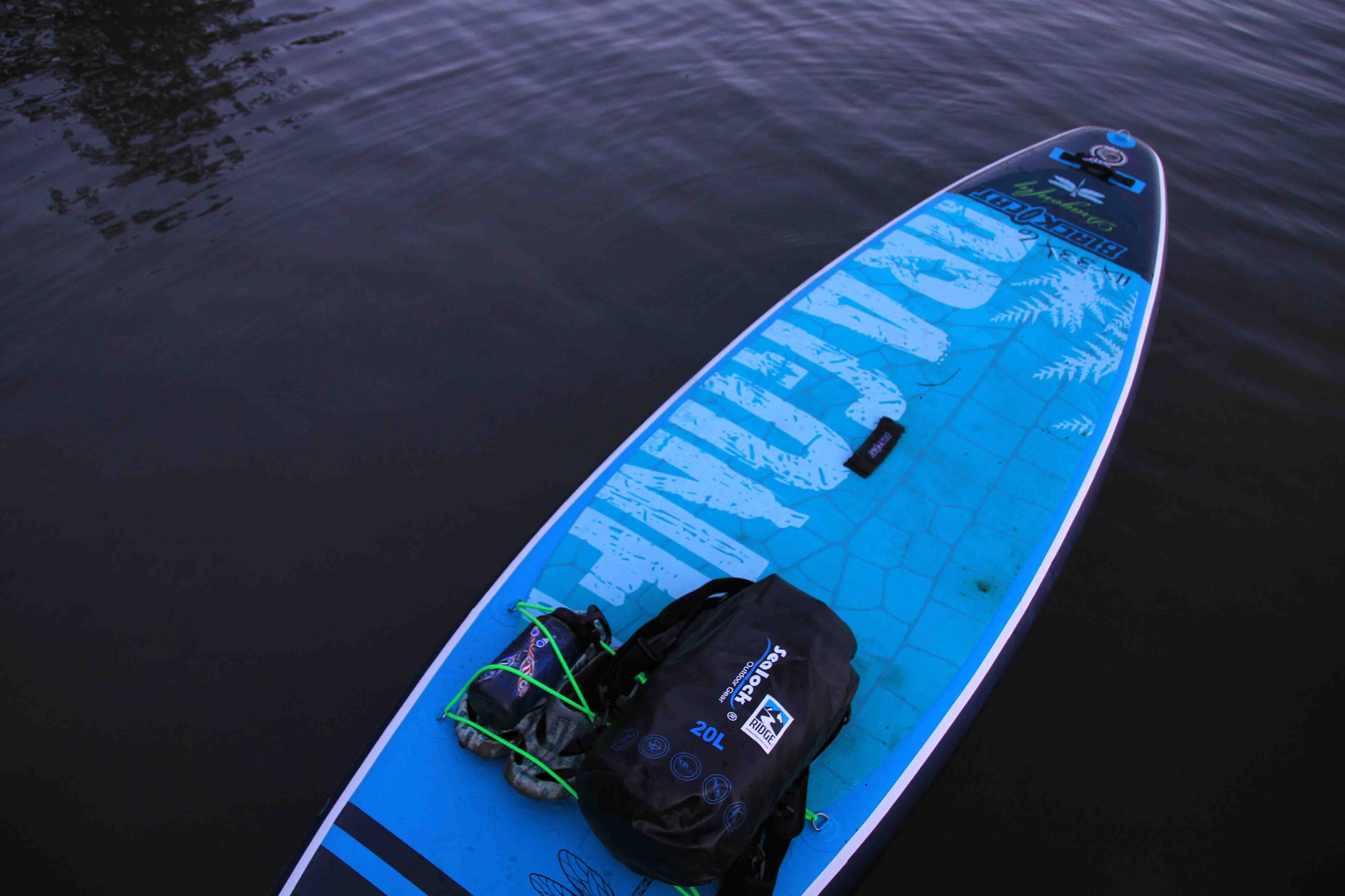 Sealock dry bag clipped by its D-ring to a kayak and floating on the surface